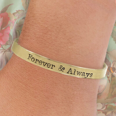 The Love Collection 1 bracelet, engraved with “Forever & Always,” shines in gold against a pink and green floral background, showcasing its simple yet elegant design and heartfelt message. Read more at Stamping Cat Studio (stampingcatstudio.com).