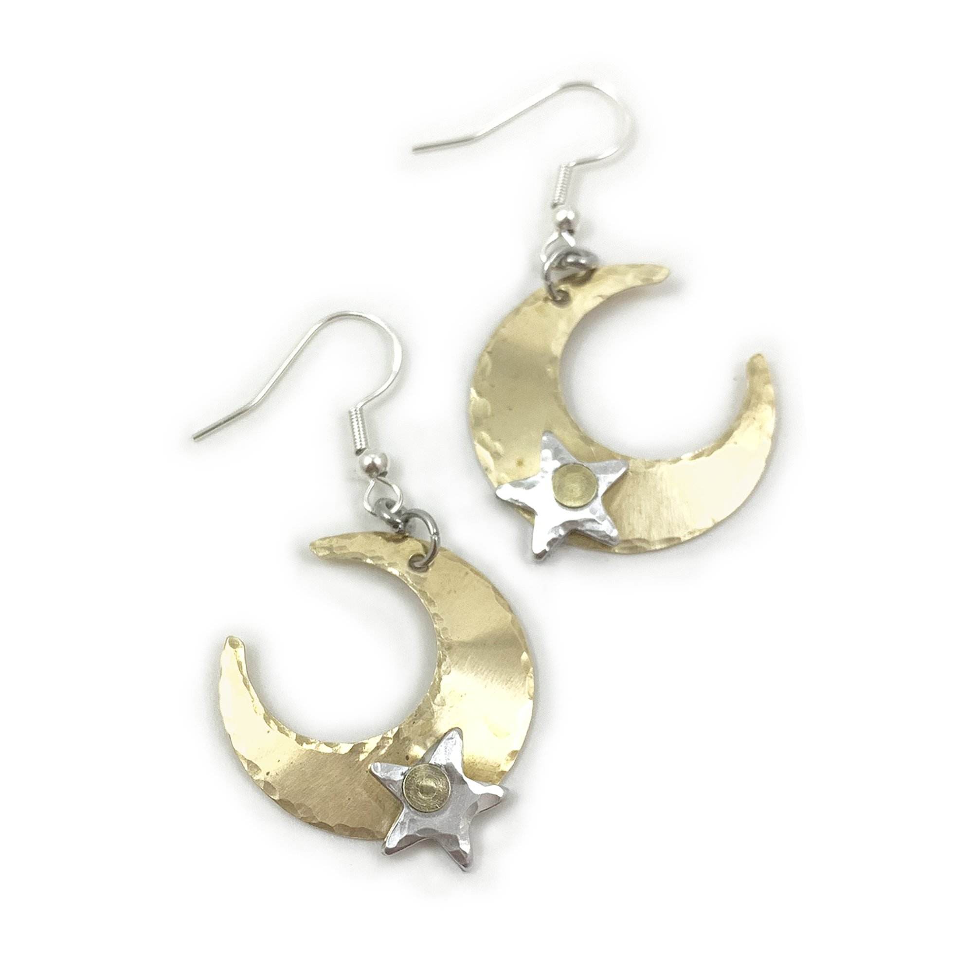 The Free Spirit Crescent Moon Earrings showcase gold hammered crescent moons with silver stars and fishhook ear wires, offering a whimsical celestial vibe in a mixed metal design. Read more at Stamping Cat Studio (stampingcatstudio.com).