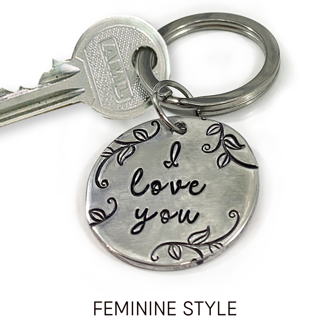 The My Love key ring feminine words is displayed: a silver key and round metal key ring engraved with "I love you" plus vine and leaf designs. The phrase "FEMININE STYLE" appears below on a white background. Read more at Stamping Cat Studio (stampingcatstudio.com).