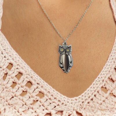 The Cute Owl Pendant Neck 2c, featuring yellow gemstone eyes and detailed silver feather patterns, rests at the center of the chest above a light pink crocheted top with a deep V neckline. Read more at Stamping Cat Studio (stampingcatstudio.com).