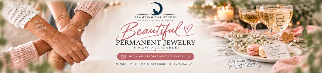 Two hands adorned with Beautiful Permanent Jewelry gold bracelets from Stamping Cat Studio touch gently. Beside them, glasses of champagne, pink macarons, and flowers rest on a white table. Text reads “Beautiful Permanent Jewelry by Stamping Cat Studio is now available!” with booking details and a heart graphic. Read more at Stamping Cat Studio (stampingcatstudio.com).