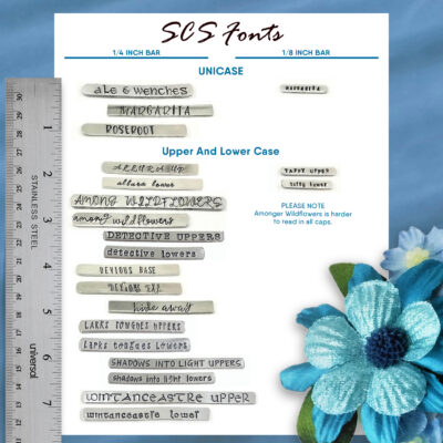 A chart displays 13 metal font samples for stamping the “Follow Your Heart It Knows The Way Key Ring,” labeled by size with a ruler. Blue text marks unicase and case styles. A blue flower decorates the corner, and a note flags small caps as hard to read for “Among Wildflowers.”. Read more at Stamping Cat Studio (stampingcatstudio.com).