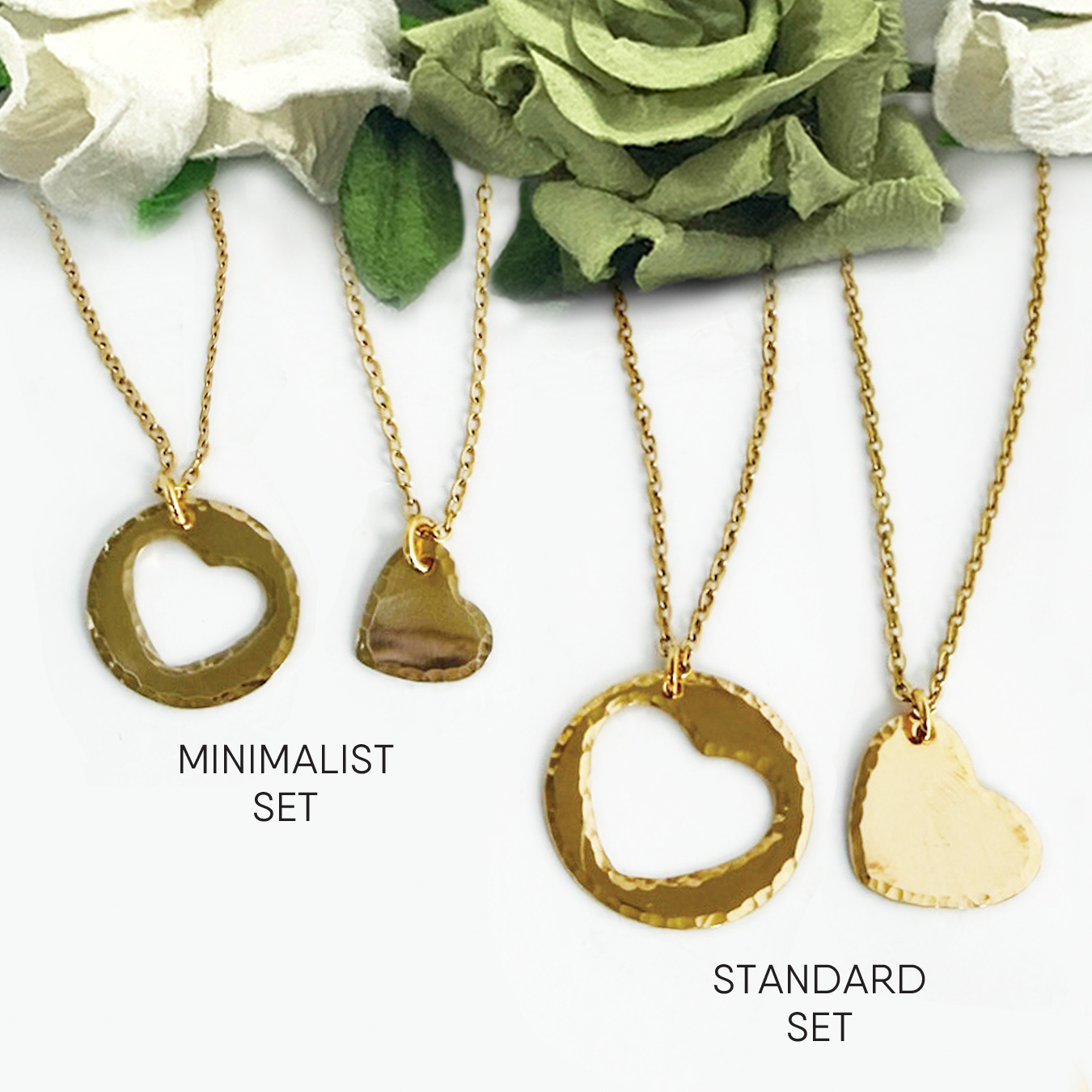 Two Couples Sets NuGold are shown on a white background with green and white flowers. The Minimalist set features small open circle and heart pendants; the Standard set has larger versions. Both have hammered textures and gold chains. Read more at Stamping Cat Studio (stampingcatstudio.com).