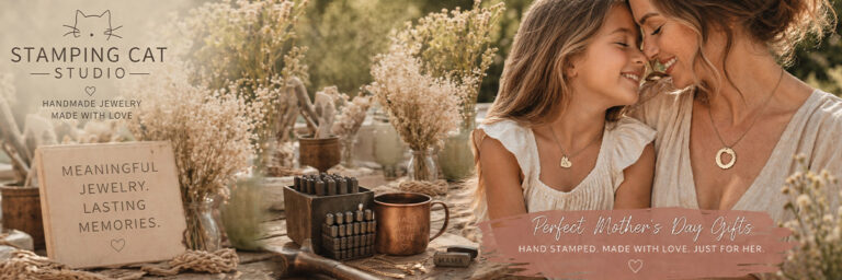 A mother and daughter smile outdoors, wearing stamped jewelry. Surrounded by flowers, a mug, and metal stamps, a sign reads MEANINGFUL JEWELRY. LASTING MEMORIES. Shop meaningful Mother’s Day gifts at Stamping Cat Studio. Read more at Stamping Cat Studio (stampingcatstudio.com).